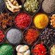 Colourful background from various herbs and spices for cooking in bowls. Top view